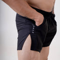 Close-up side view of ZYAVE Men's Onyx Running Shorts featuring a deep side pocket, side split hem and lightweight performance fabric.
