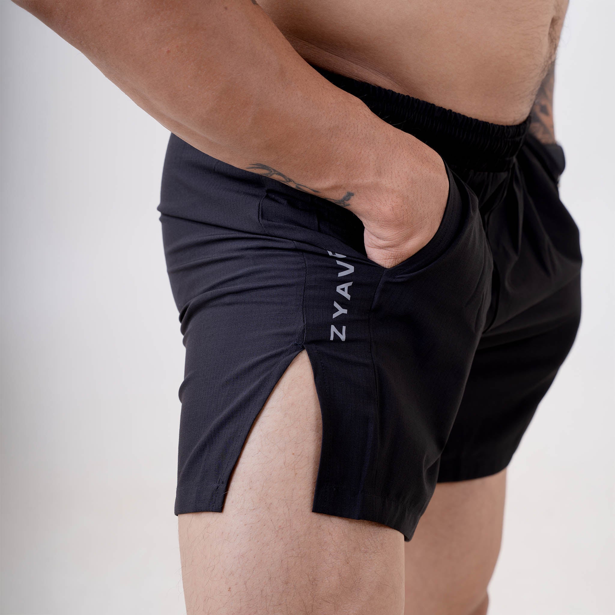 Close-up side view of ZYAVE Men's Onyx Running Shorts featuring a deep side pocket, side split hem and lightweight performance fabric.